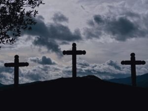 Three crosses silhouetted against a cloudy sky