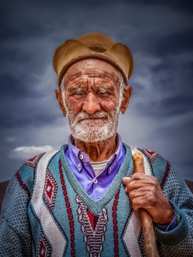 Elderly man with a weathered face and a staff